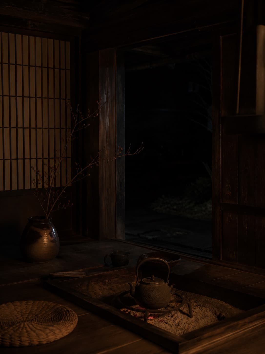 夜の古い家で火にかかる鉄瓶
